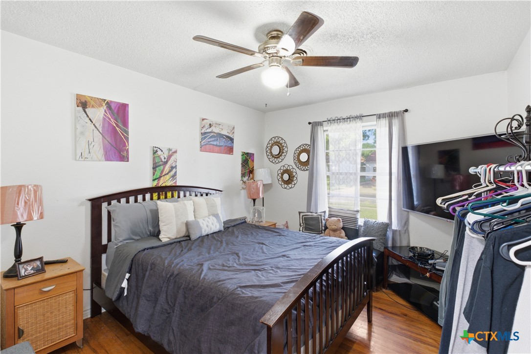 503 Cardinal Avenue Killeen, TX 76541 - Photo 15 of 26 a bedroom with a bed and a chandelier
