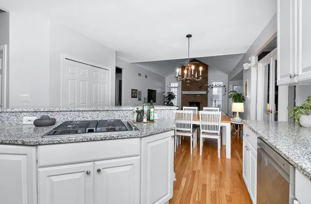 a kitchen with center island table and chairs in it