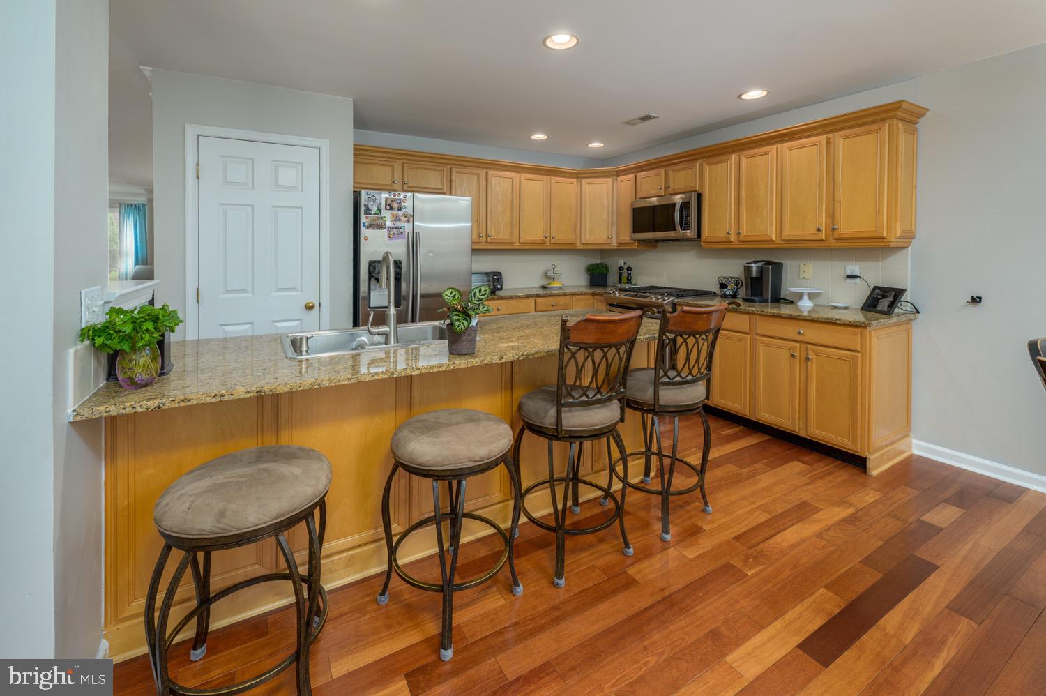 24 Hogan Way Moorestown, NJ 08057 - Photo 8 of 15 a kitchen with stainless steel appliances granite countertop wooden cabinets a stove a sink and a microwave