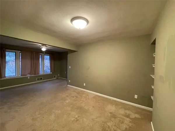 an empty room with windows and entrance