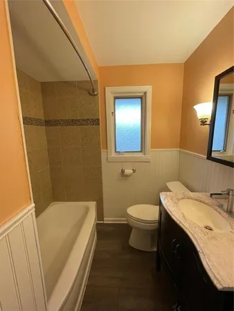 a bathroom with a sink a toilet and mirror