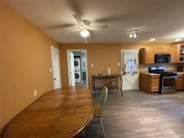 a view of a kitchen with furniture and wooden floor