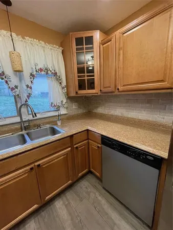 a kitchen with stainless steel appliances granite countertop a sink and a granite counter tops with a large window