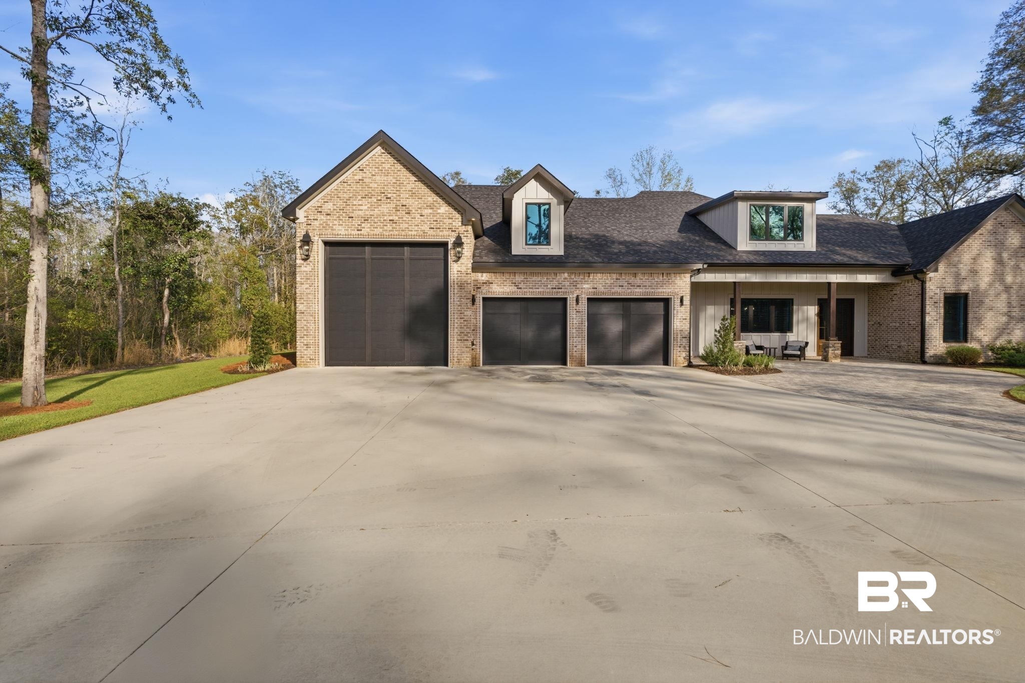 9501 Ben Hamilton Road Theodore, AL 36582 - Photo 8 of 69 View of front of home with brick siding, an attached garage, concrete driveway, and roof with shingles