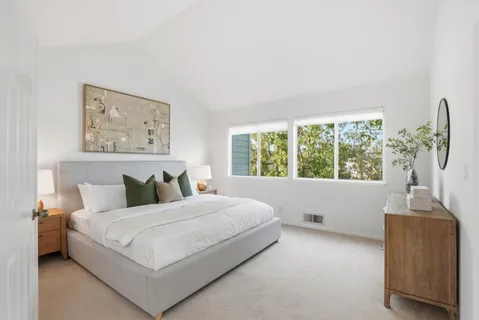 a bedroom with a large bed and a window