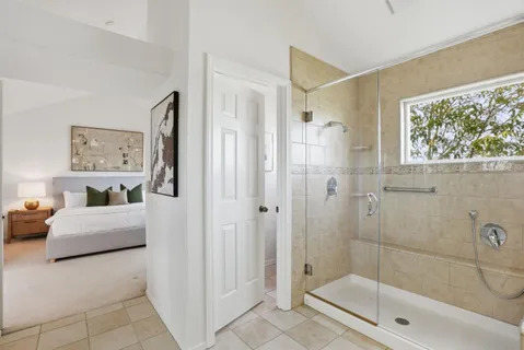 a bathroom with a shower sink and mirror