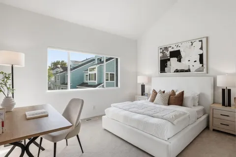 a bedroom with a large bed and a desk