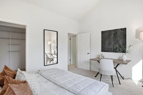 a bedroom with a bed and chair