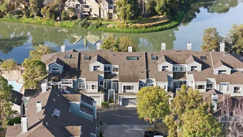 an aerial view of a house with a lake view