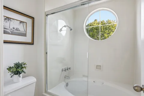 a bathroom with a tub and a shower