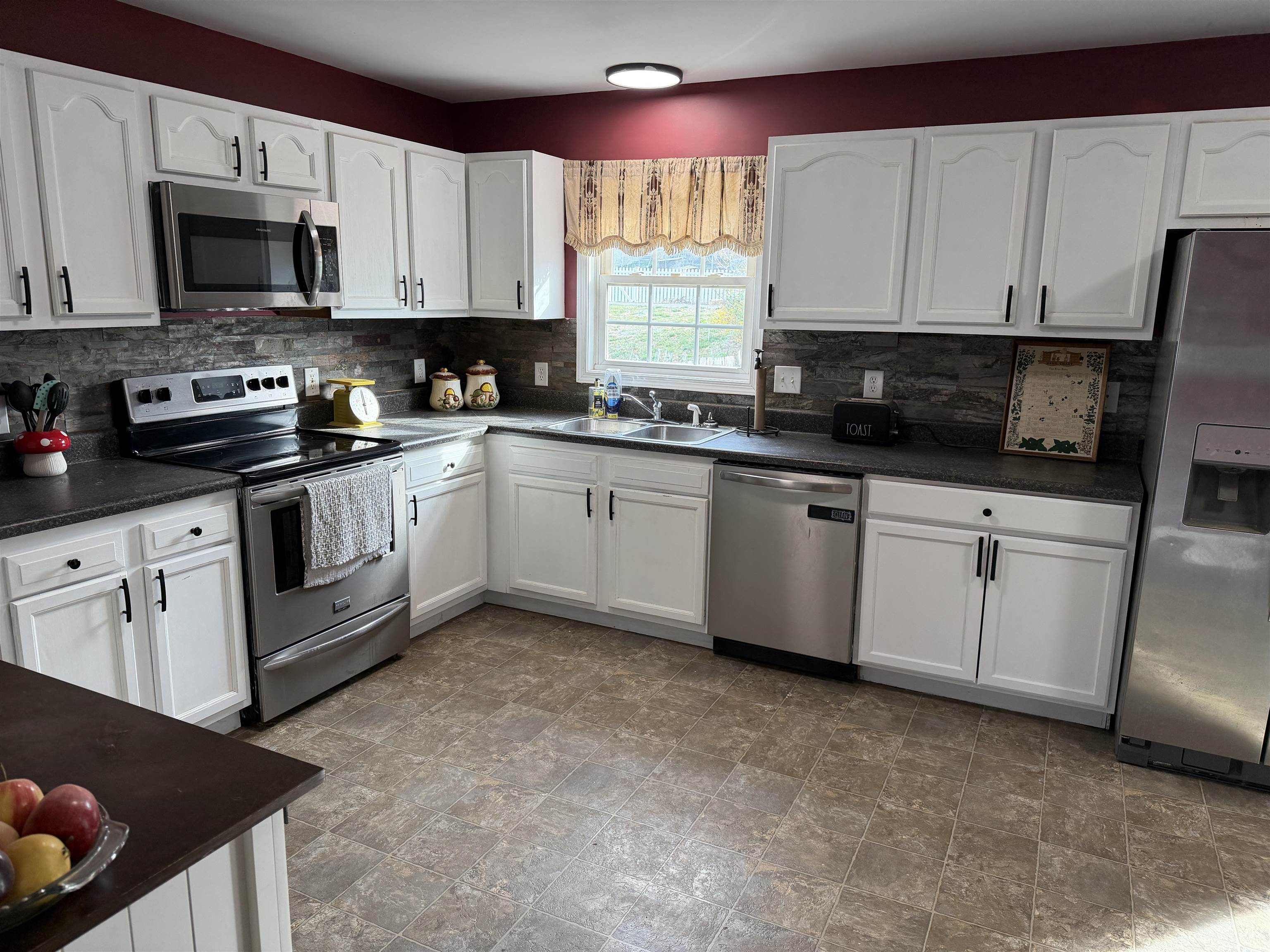 1520 3rd Street Waynesboro, VA 22980 - Photo 16 of 55 a kitchen with stainless steel appliances granite countertop a stove a sink and a microwave