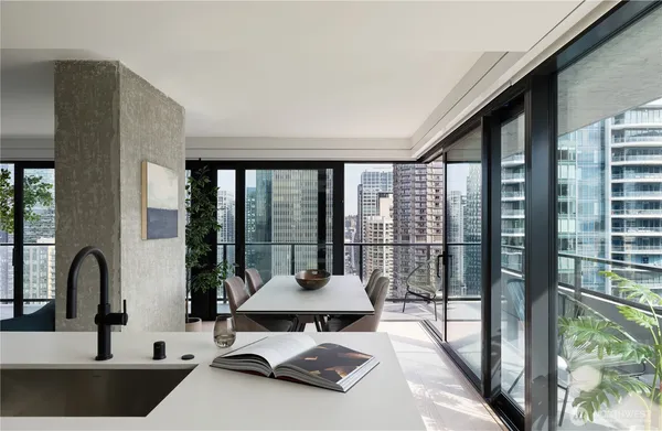 a living room with a large window and a sink