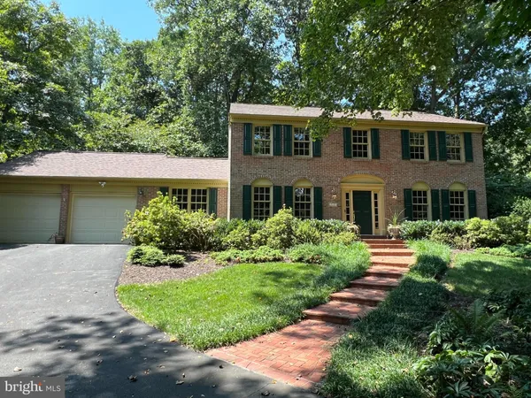 a front view of a house with a yard and outdoor seating