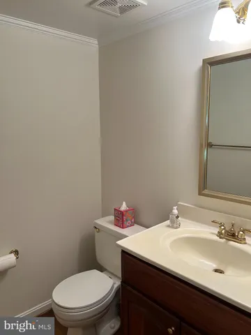 an empty room with wooden floor fireplace and windows