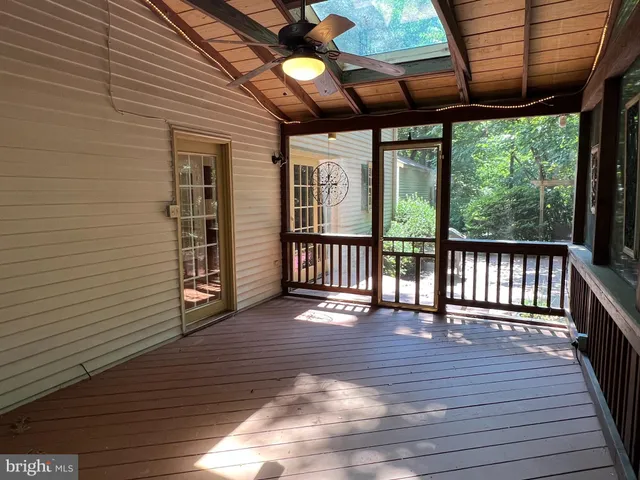 a view of kitchen with stainless steel appliances granite countertop cabinets and wooden floor