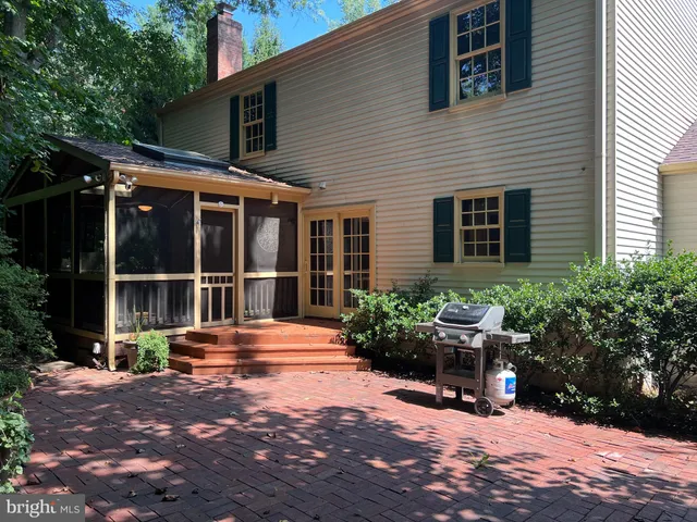 a kitchen with granite countertop wooden cabinets and a stove top oven