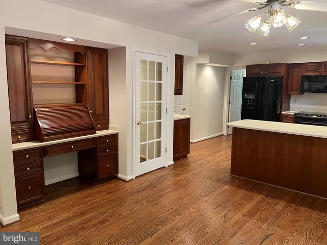 a kitchen with wooden cabinets and center island