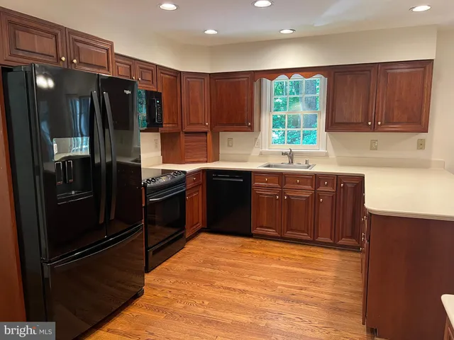 a view of a room with wooden floor and chandelier