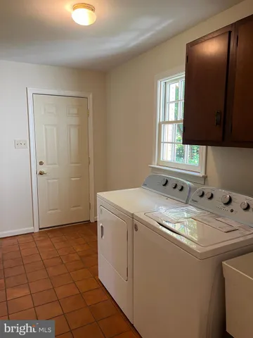 a view of staircase with railing and a window