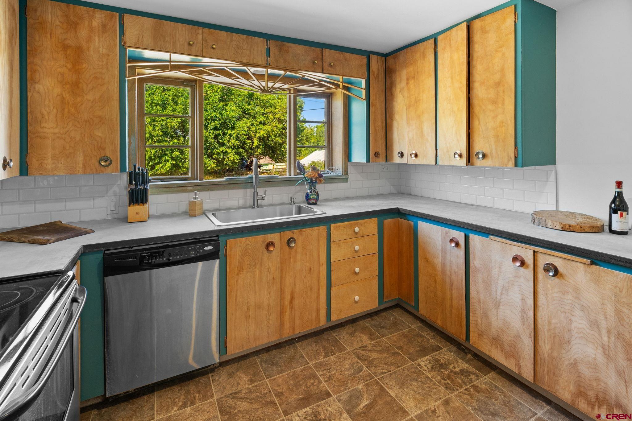 554 Main Street Nucla, CO 81424 - Photo 13 of 41 a kitchen with a sink stove and cabinets