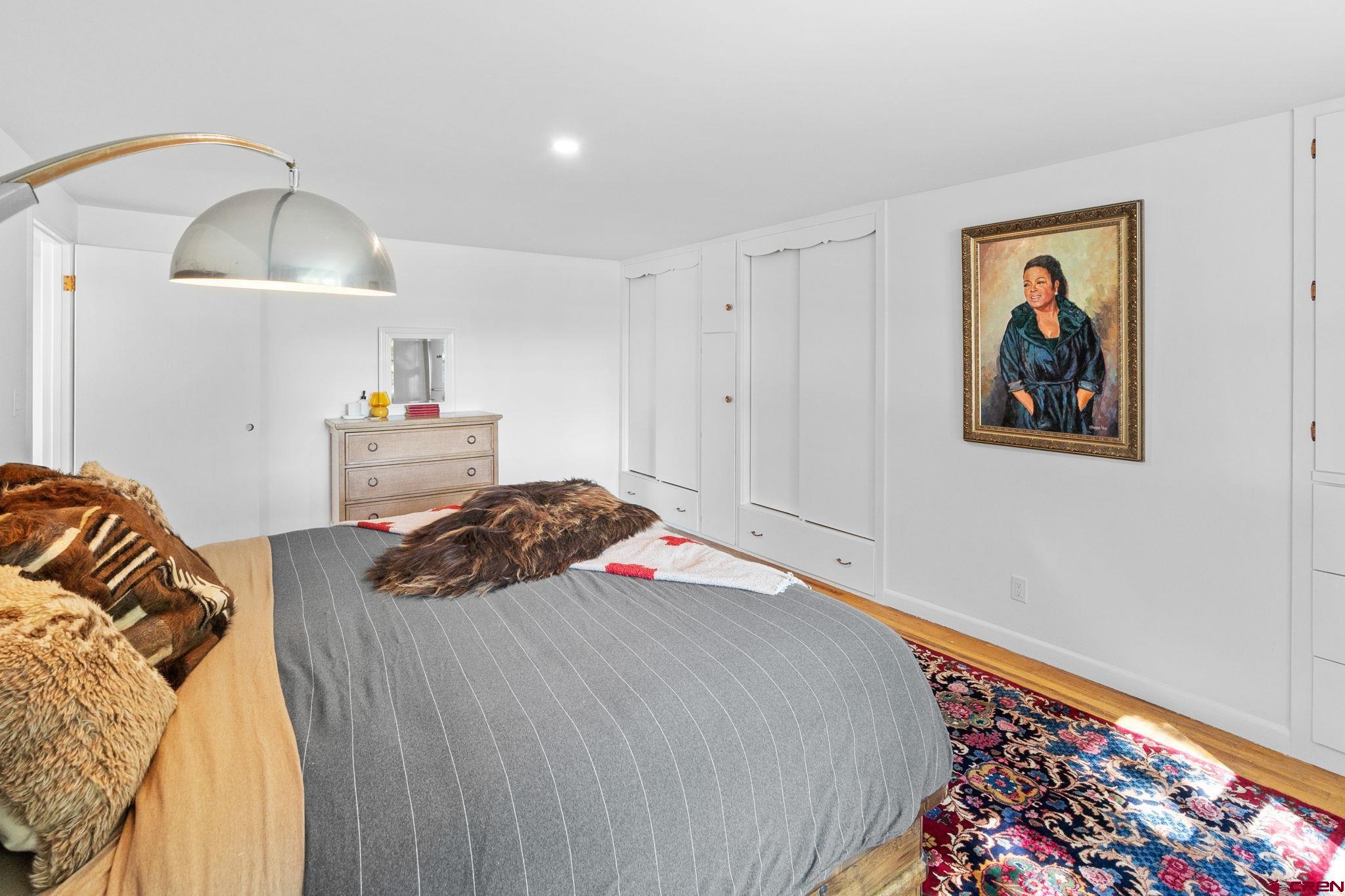 554 Main Street Nucla, CO 81424 - Photo 17 of 44 a bedroom with a bed and a lamp