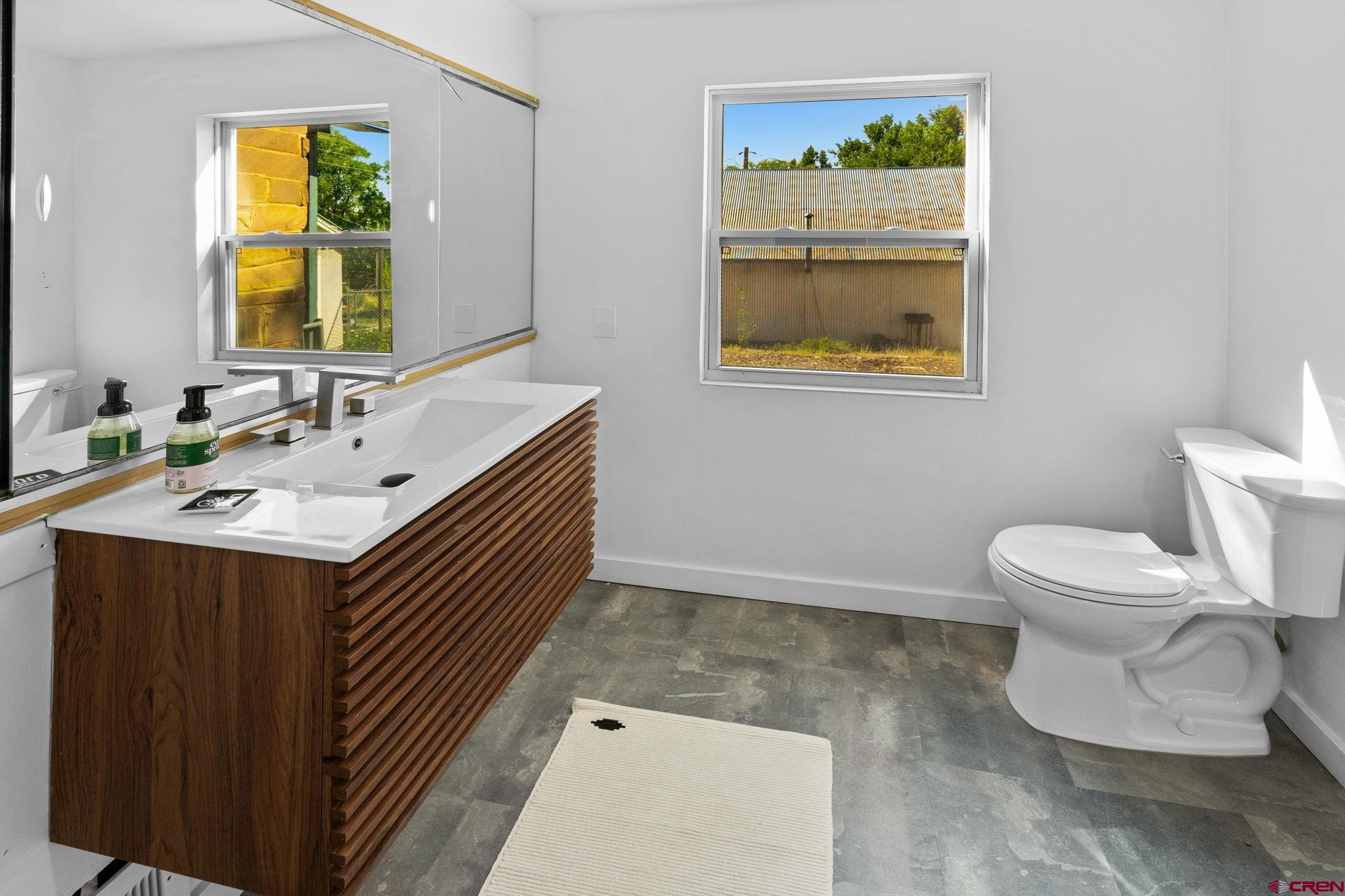554 Main Street Nucla, CO 81424 - Photo 18 of 44 a bathroom with a sink a mirror and a toilet