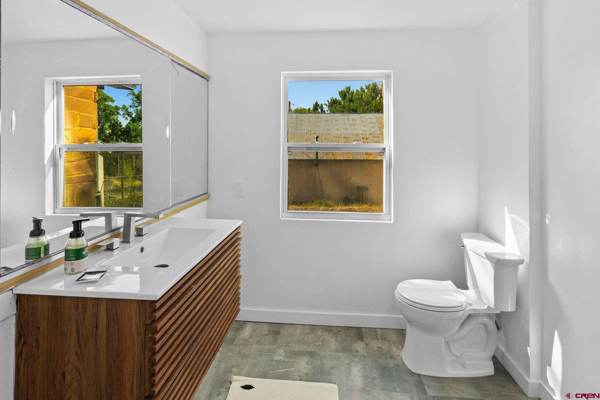 554 Main Street Nucla, CO 81424 - Photo 21 of 41 a bathroom with a sink a toilet and mirror