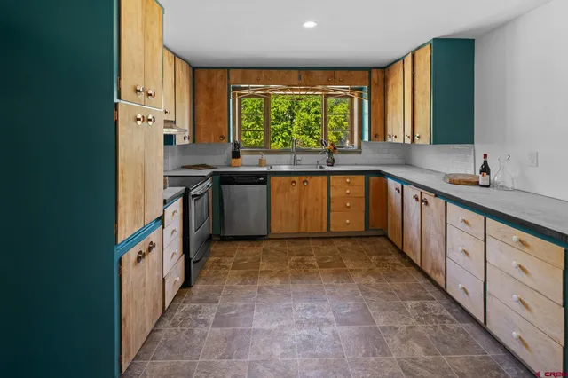 a kitchen with stainless steel appliances a sink and a stove