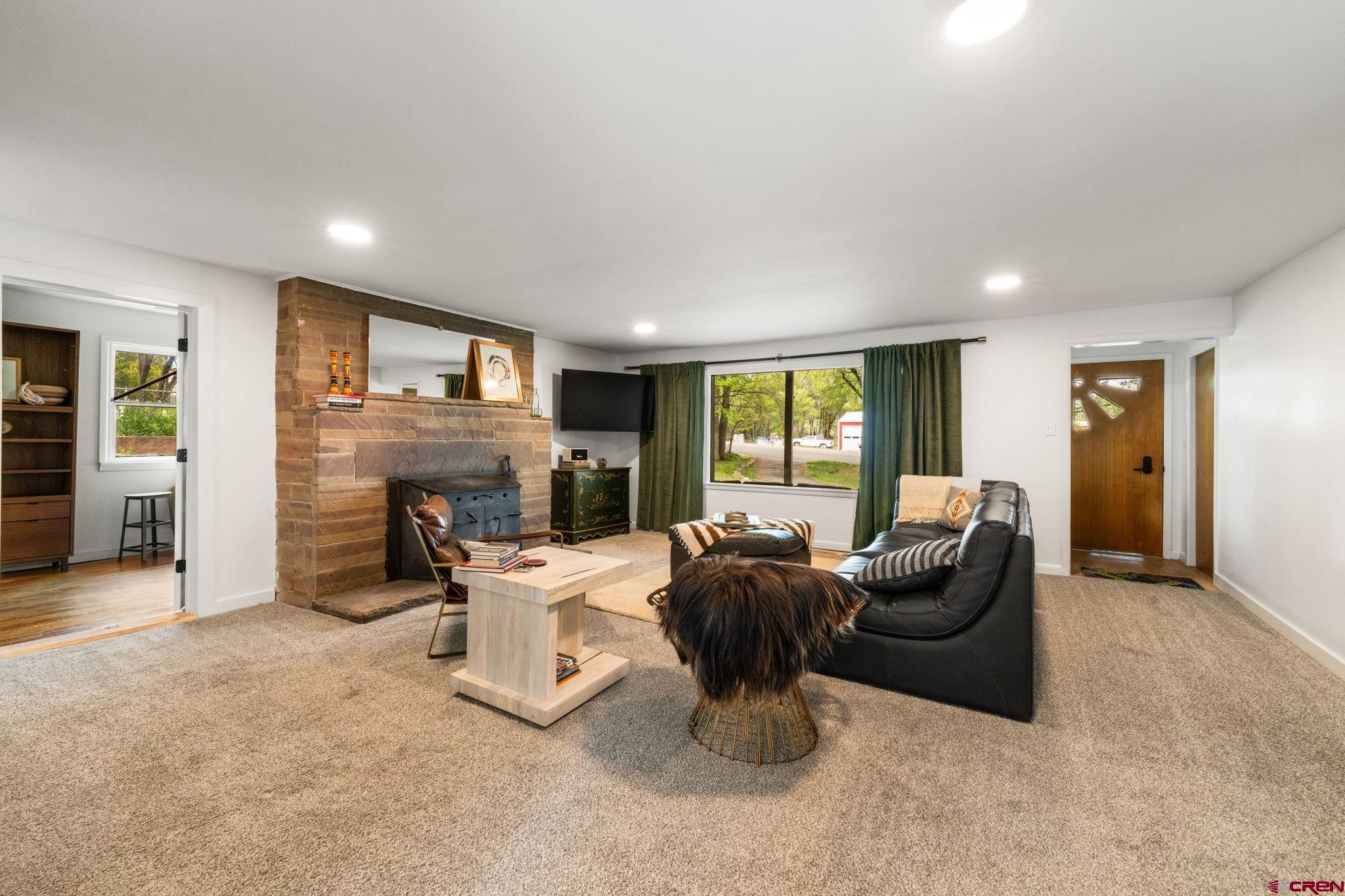 554 Main Street Nucla, CO 81424 - Photo 28 of 41 a living room with furniture a fireplace and a large window