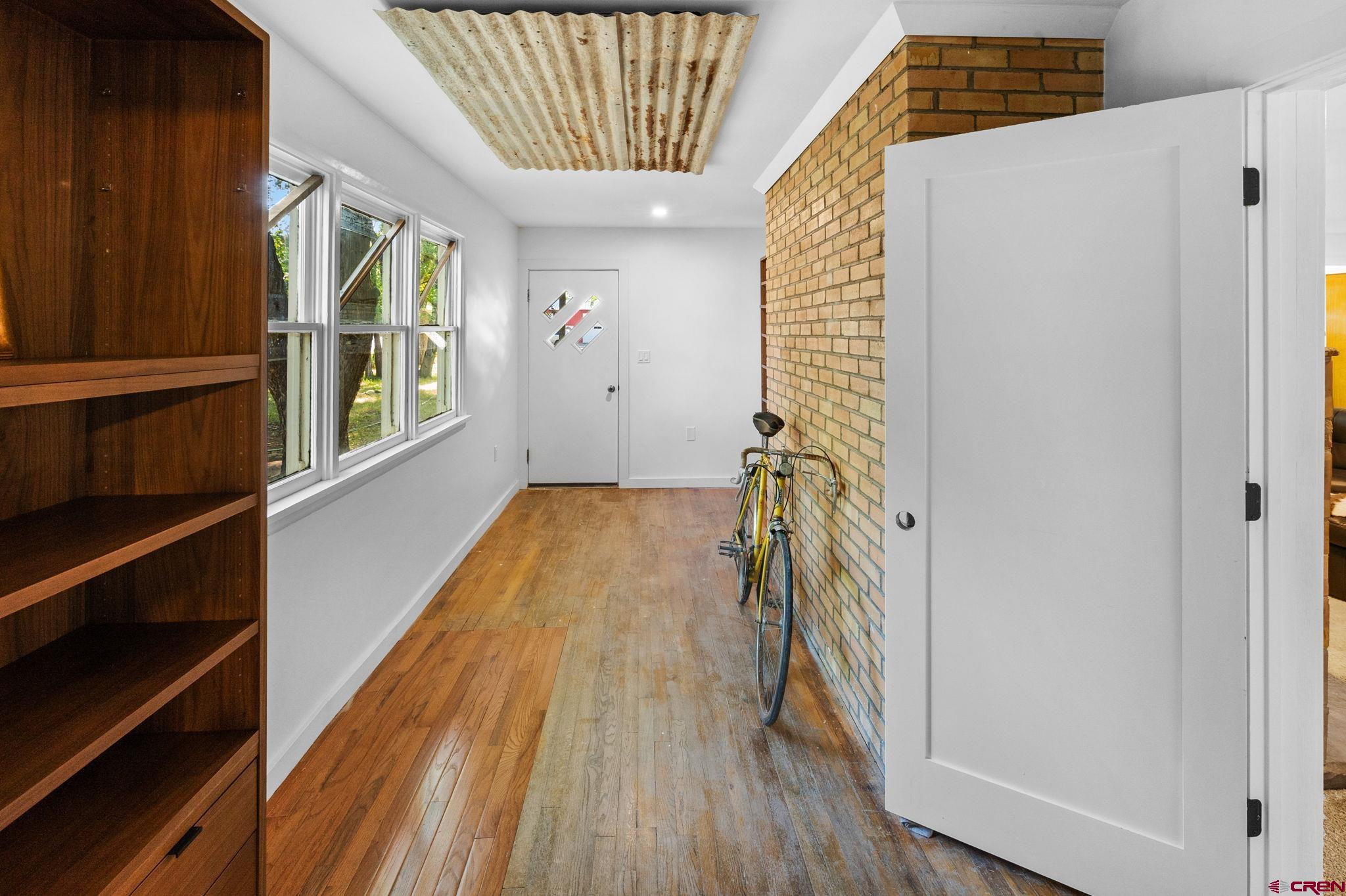 554 Main Street Nucla, CO 81424 - Photo 30 of 41 a view of a hallway with wooden floor and staircase