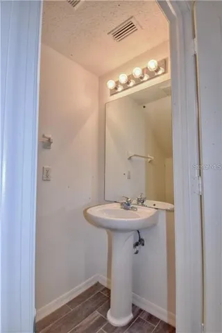 a bathroom with a sink a mirror and a vanity