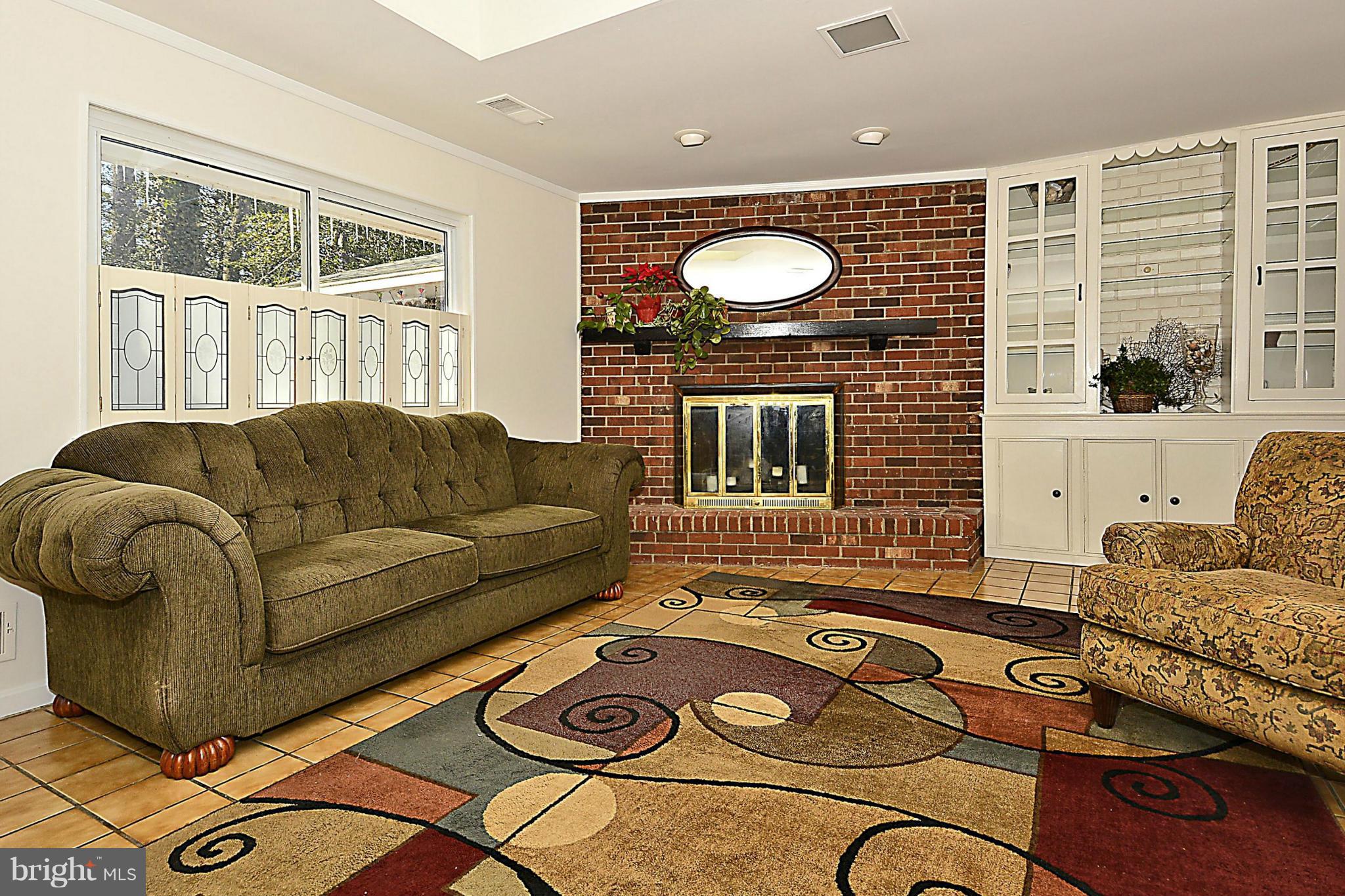 18506 Cabin Road Triangle, VA 22172 - Photo 15 of 30 Cozy Wood Burning Fireplace with Brick Hearth