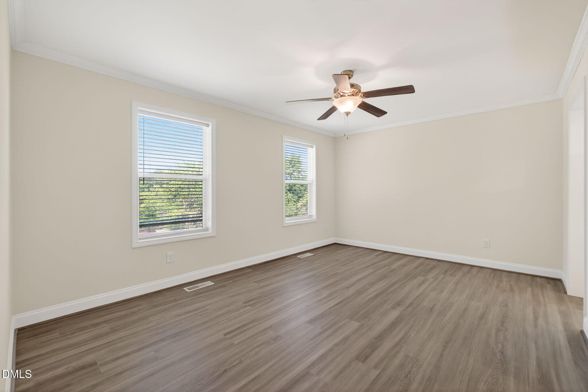 7122 Guess Road Hillsborough, NC 27278 - Photo 26 of 48 an empty room with wooden floor ceiling fan and windows