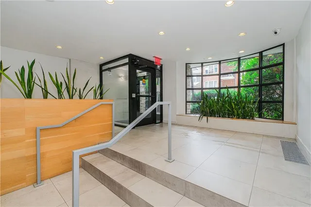 a view of a hallway with furniture