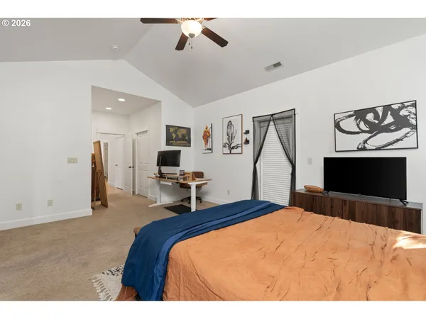 a bedroom with a bed and a flat screen tv