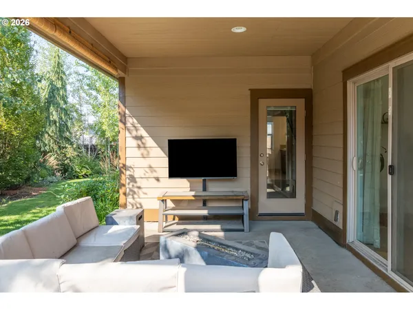 a living room with couches bookshelf and a flat screen tv