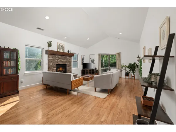 a living room with furniture wooden floor and a fireplace