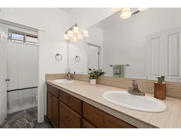 a bathroom with a sink double vanity and a mirror