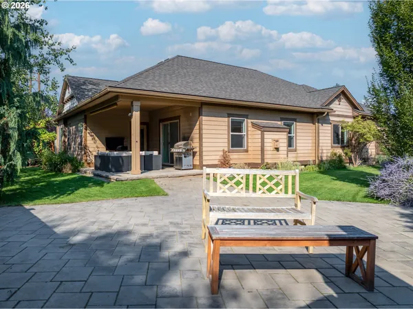 a sign board with a bench and table