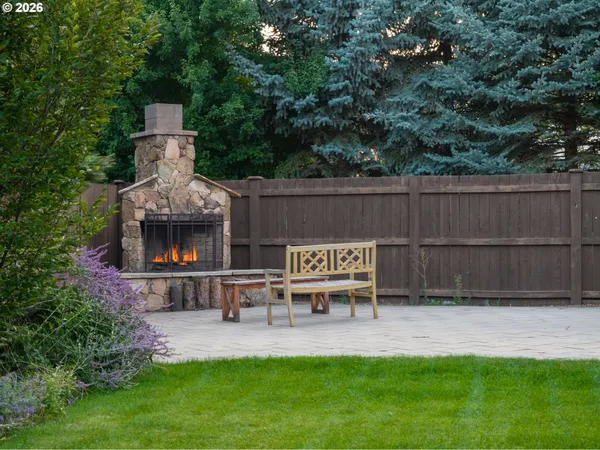 a view of a chair and table in the garden