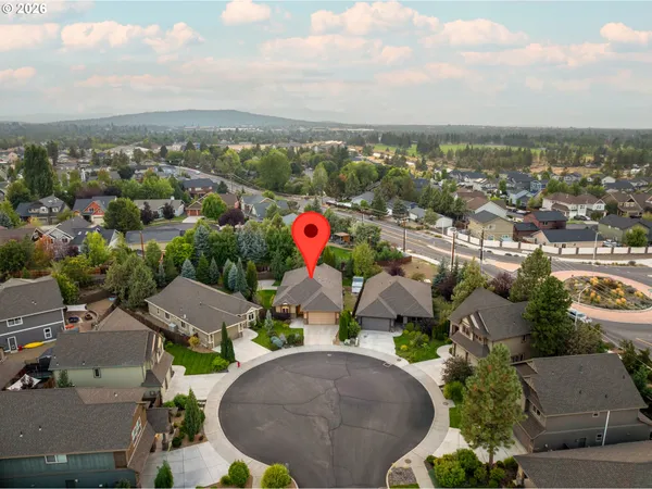 an aerial view of residential houses with outdoor space and parking