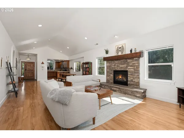 a living room with furniture a fireplace and a table