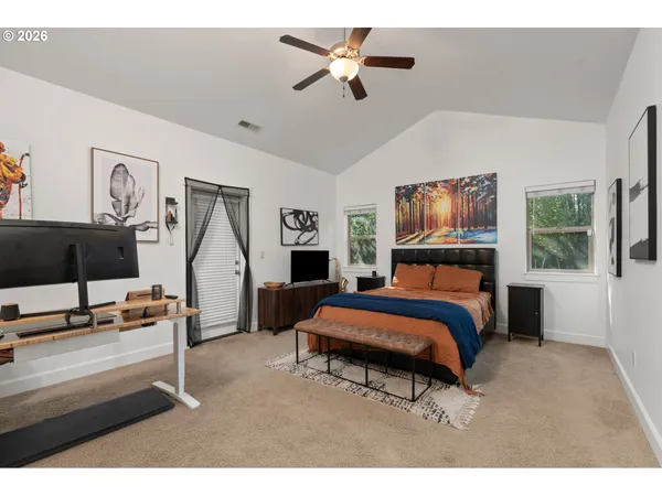 a bedroom with furniture and a flat screen tv