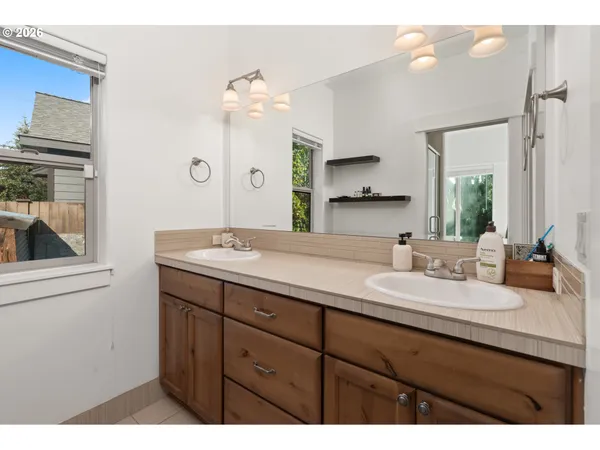 a bathroom with a sink double vanity granite and a mirror