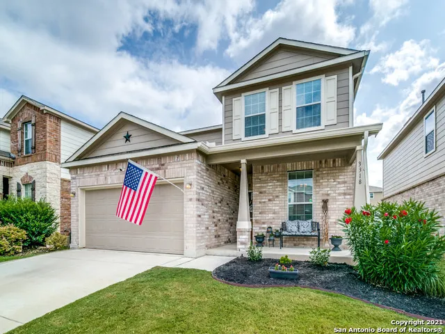 a front view of house and yard with trees