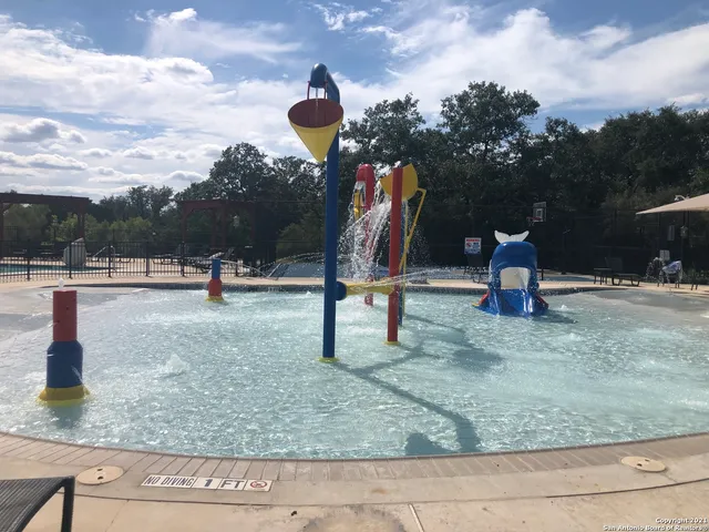 a view of a patio with table and chairs under an umbrella
