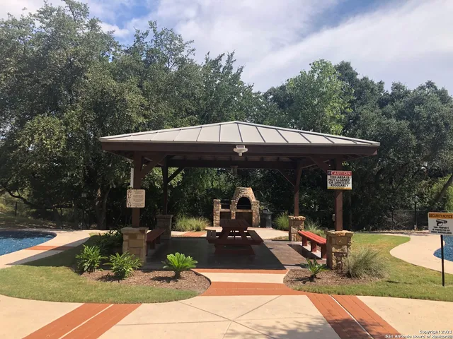 a swimming pool with outdoor seating and city view