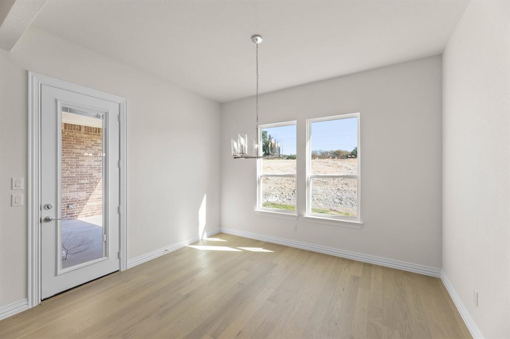 325 Slimp Bluff Azle, TX 76020 - Photo 11 of 25 a view of an empty room with wooden floor and a window