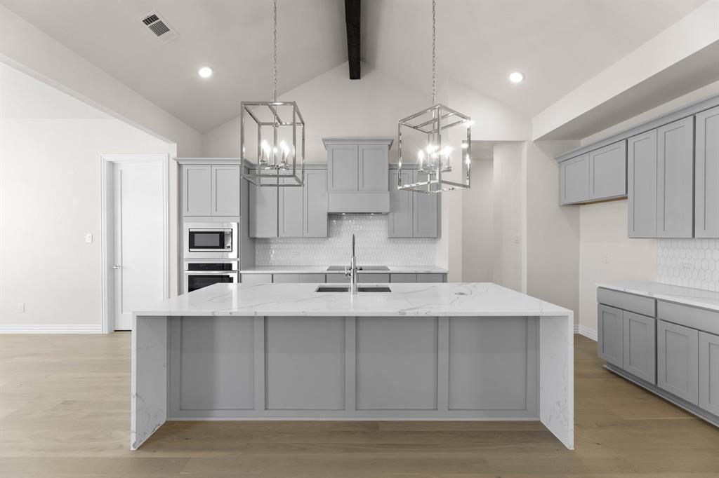 325 Slimp Bluff Azle, TX 76020 - Photo 12 of 25 a large kitchen with kitchen island a sink stainless steel appliances and cabinets