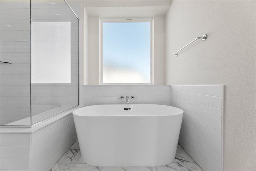 325 Slimp Bluff Azle, TX 76020 - Photo 19 of 25 a white bath tub sitting in a bathroom